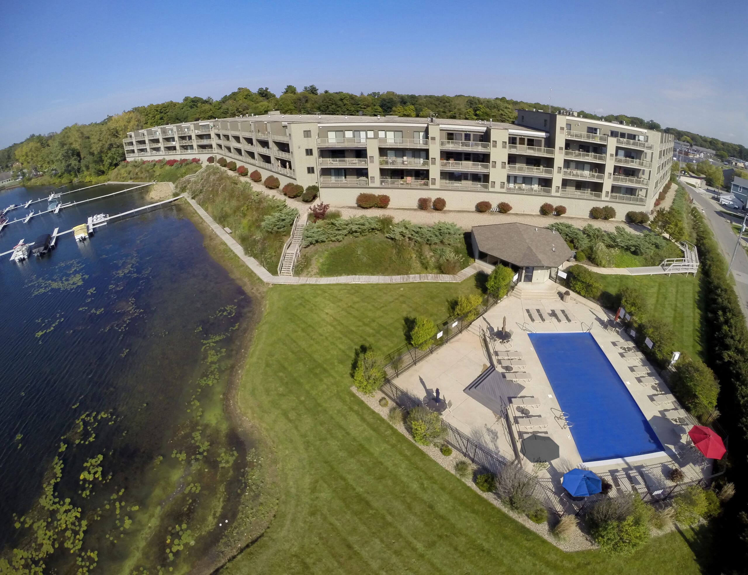 Aerial view of lakefront condominiums with private docks and a swimming pool designed by GMF Architecture.