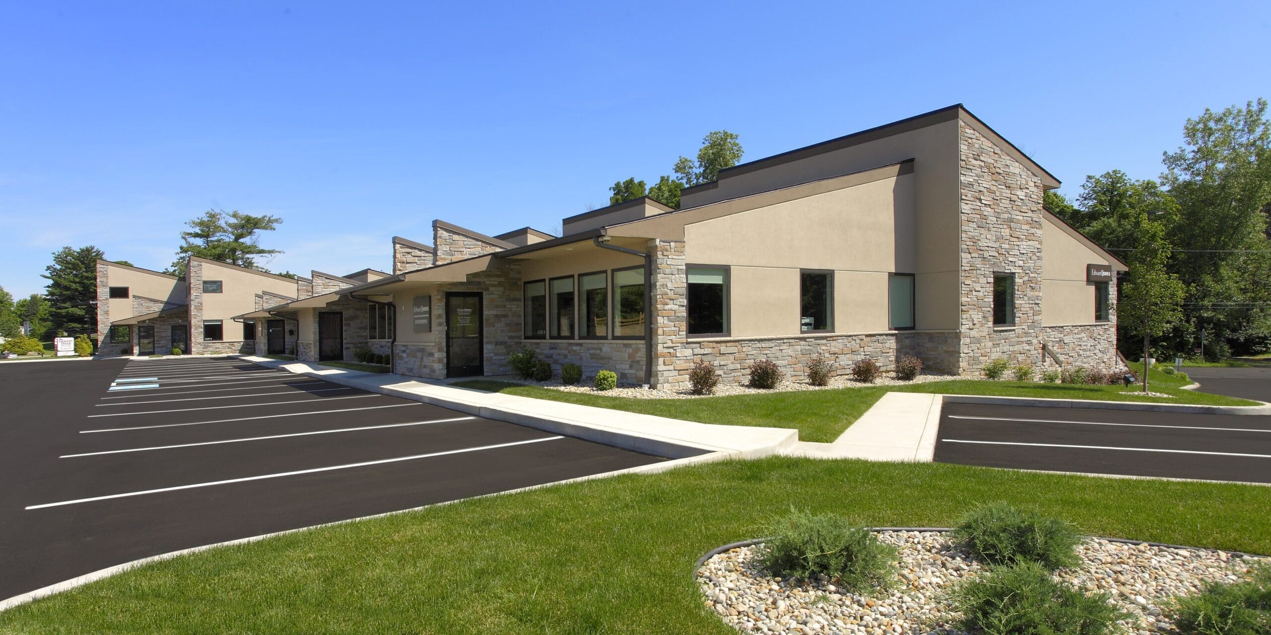 Modern commercial office building with stone and stucco exterior designed by GMF Architecture & Development.