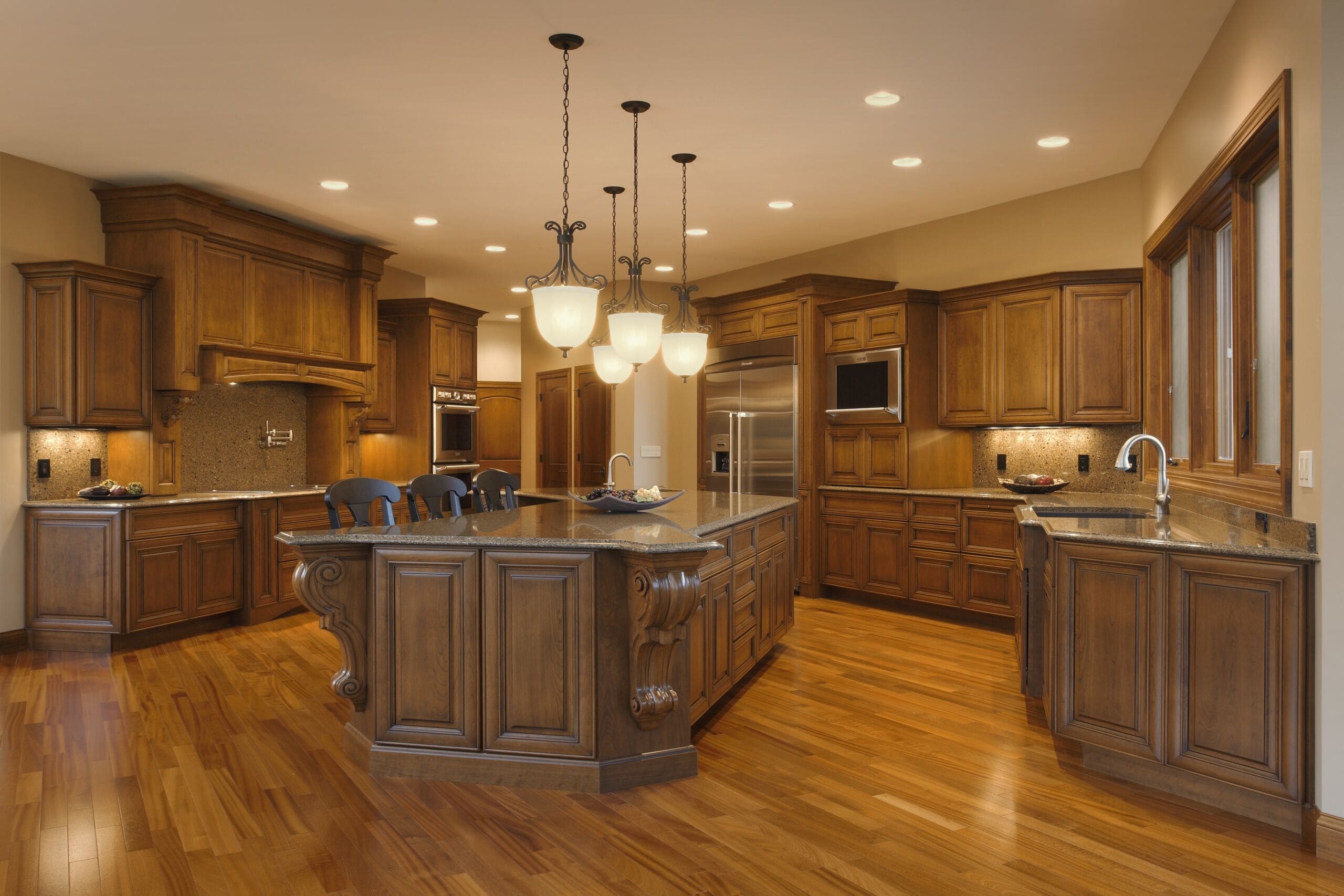 Custom luxury kitchen interior designed by GMF Architecture & Development featuring wood cabinetry and granite countertops.